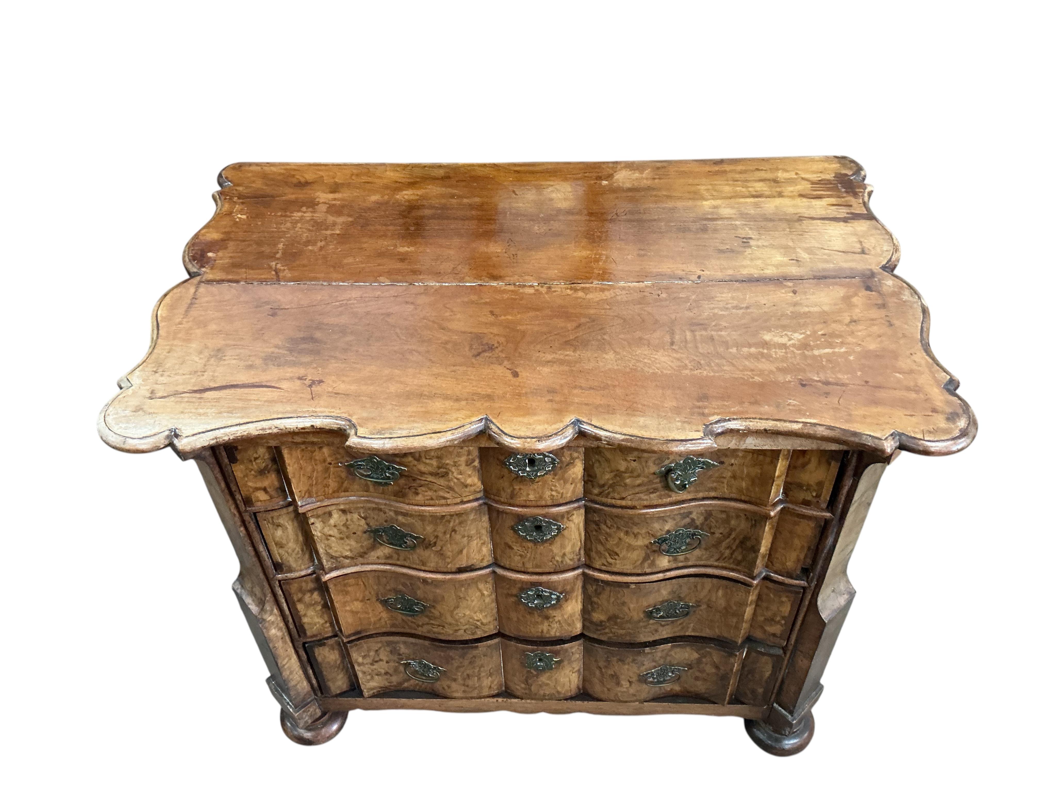 An 18th century Dutch walnut and oak serpentine chest, width 92cm, depth 57cm, height 78cm